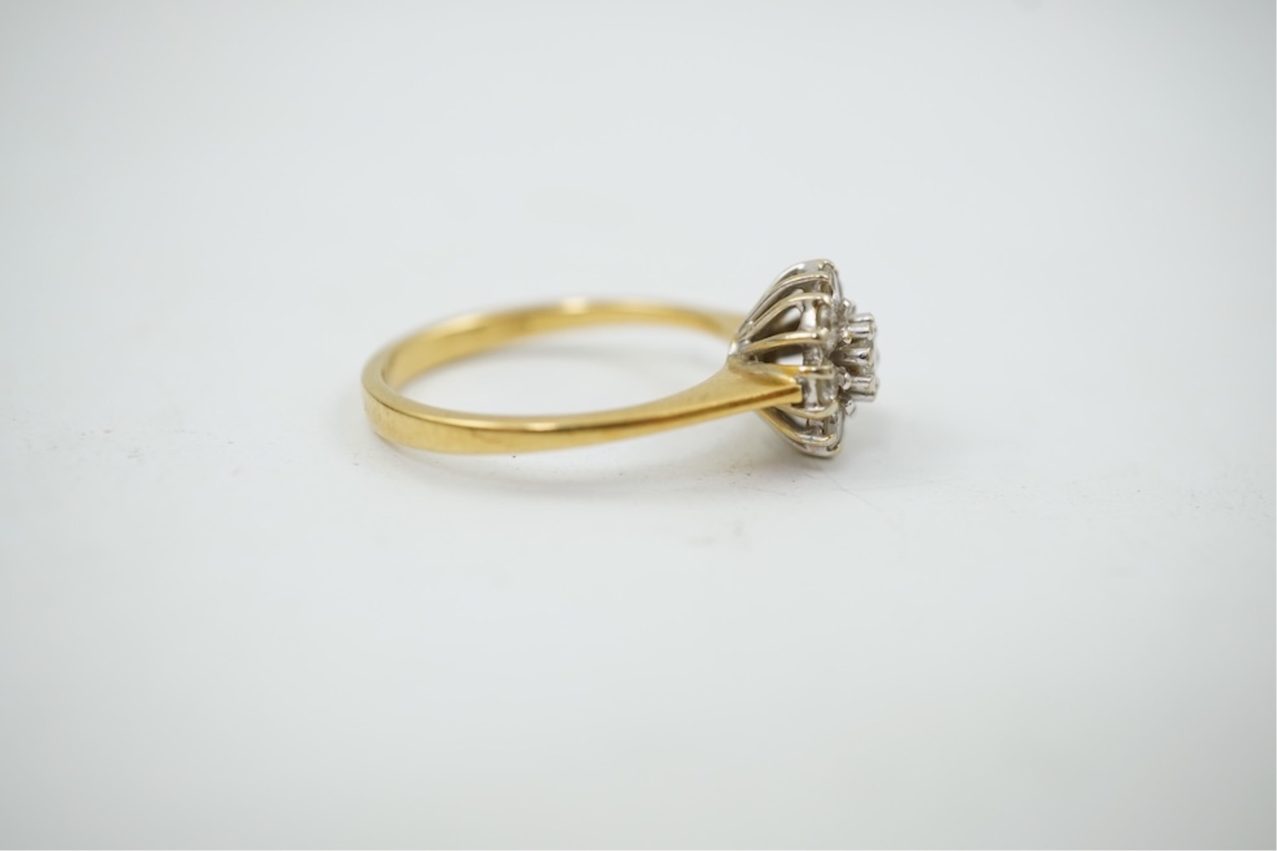 A modern 18ct gold and diamond set circular cluster ring, size M, gross weight 3.2 grams.